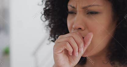 Close up view of woman coughing at home