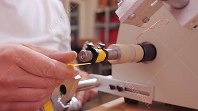 Hand making electronic component on coil winding machine - camera orbit