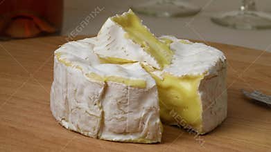 Mature camembert cheese and a piece close up