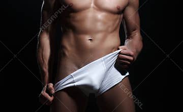 Sexy torso of a muscular man. Fitness model in underwear.