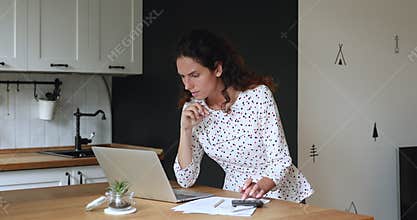 Woman calculates personal finances feels stressed about overspend negative balance