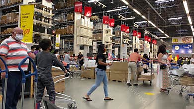 People shopping at Ikea while wearing face masks and social distancing