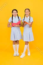 Sincere interest. Little girls with encyclopedia or childrens books. School library. Educational books for school