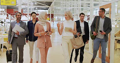 Business people talking and walking in a conference foyer
