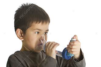 Cute young boy using his asthma inhaler