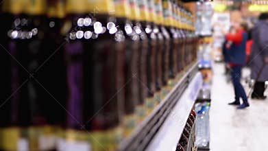 Alcohol sale in supermarket. Rows and shelves of bottled beer on a store window