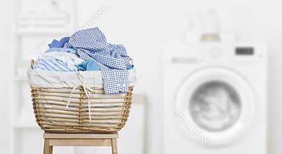 Laundry basket on blurred background of modern washing machine