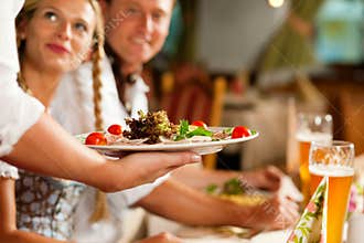 Waitress serving an Bavarian Restaurant