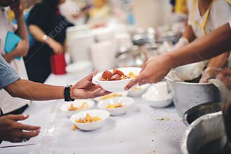 The poor reach out to receive donated food: Homeless people receive free charity food