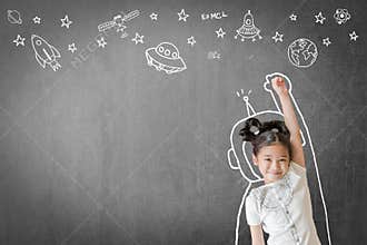 Kid`s learning inspiration in science education with girl child`s imagination doodle on teacher`s school chalkboard for back to sc