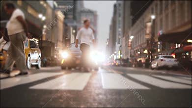 Atmospheric slow motion shot of big crowd legs crossing a busy city street near Times Square, New York in the evening.