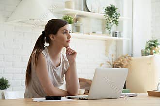 Thoughtful young woman thinking using business vision calculating finance rates.