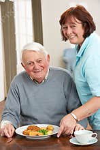 Senior Man Being Served Meal By Carer