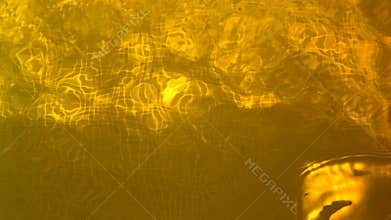 Abstract motion gold sparkle waves like material flowing, golden metallic background