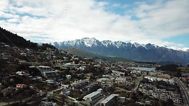 Queenstown, New Zealand. Aerial View of City Under Southern Alps Mountains