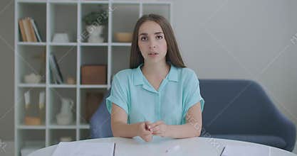 Head shot portrait woman looking at camera makes video call. Woman in front of a computer team working in video