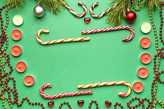 Christmas frames with candies, candles and pine sprigs with toys on a green background.
