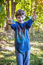 Seven year old birthday boy holding out seven fingers