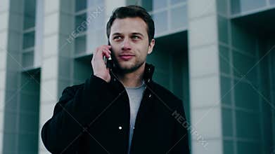 Handsome young architect man answer on phone call .