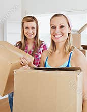Charming friends holding boxes