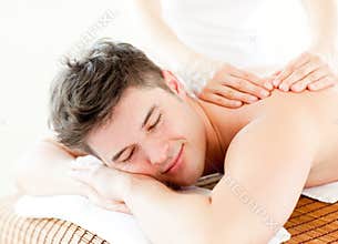 Relaxed young man receiving a back massage