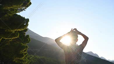 View from behind of a young woman arranging her wet hair