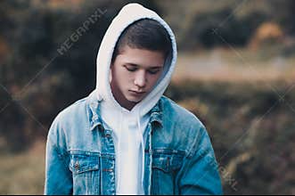 Sad teen boy outdoors