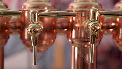 Dolly shot, of shiny beer tap ready to serve cold beer at the bar.