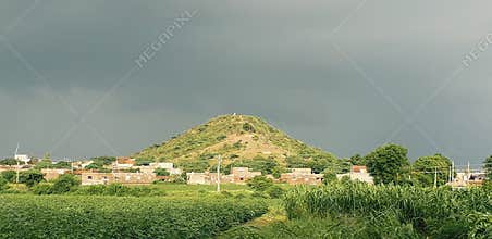 Small indian village in summer with green grass and farm
