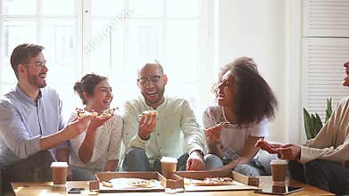 Happy multiracial young people group laughing eating pizza indoors