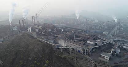 Aerial view of big factory in China. Air pollution by smoke coming out of chimneys.