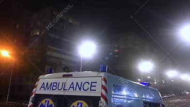 Ambulance lights flicker at night