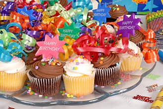 Closeup of a platter of cupcakes decorated with Happy Birthday t