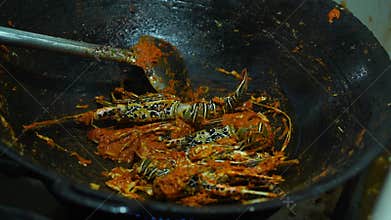 Cooking Aceh style noodles with added fresh lobsters.