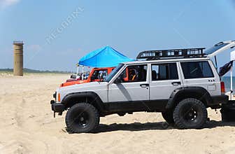 Rehoboth Beach, DE - August 12, 2023 - The cars with permit parked on the sand by Gordon\'s Pond beach area in the summer
