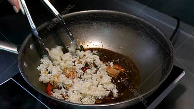 Japanese food. Shrimp with vegetables are fried in a frying pan. Cooking seafood in a sushi restaurant.