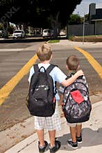 Two school children standing at crosswalk