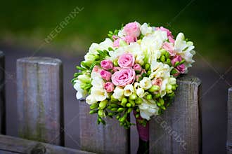 Wedding bouquet on rustic country fence