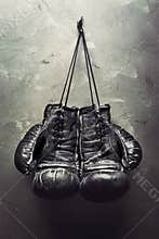 Old boxing gloves hang on nail