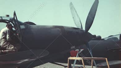 Detail of mechanics maintaining World War II fighter planes with Soviet red star