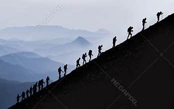 active and determined trekking of professional mountaineers to the summit and challenging sportive activities