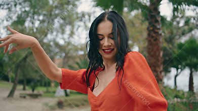 Hot beautiful woman dancer performing energetic dance in green city park closeup