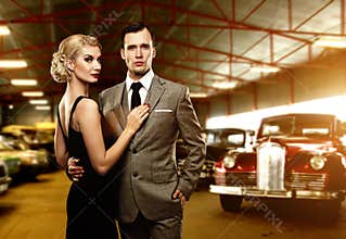 Classic couple against retro cars
