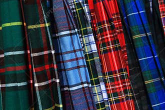Closeup variety of colourful plaid kilts.