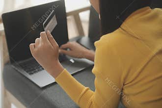 Close up of woman hand using credit card and laptop for payment and online shopping, Online shopping, payments digital banking, E-
