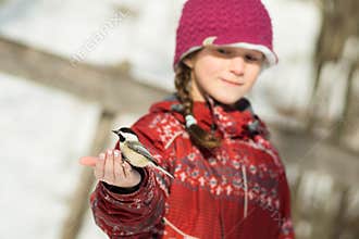 Girl feeding a bird