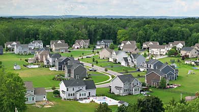 Aerial view of spacious new family houses in upstate New York suburban area. Real estate development in american suburbs