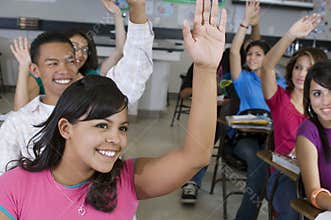 Students Raising Hands In Classroom