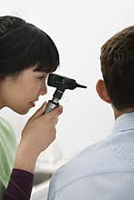 Doctor Examining Patient's Ear