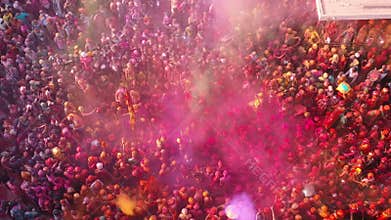 Aerial footage of people celebrating the holi color festival at Nandgaon Temple, Uttar Pradesh, India.